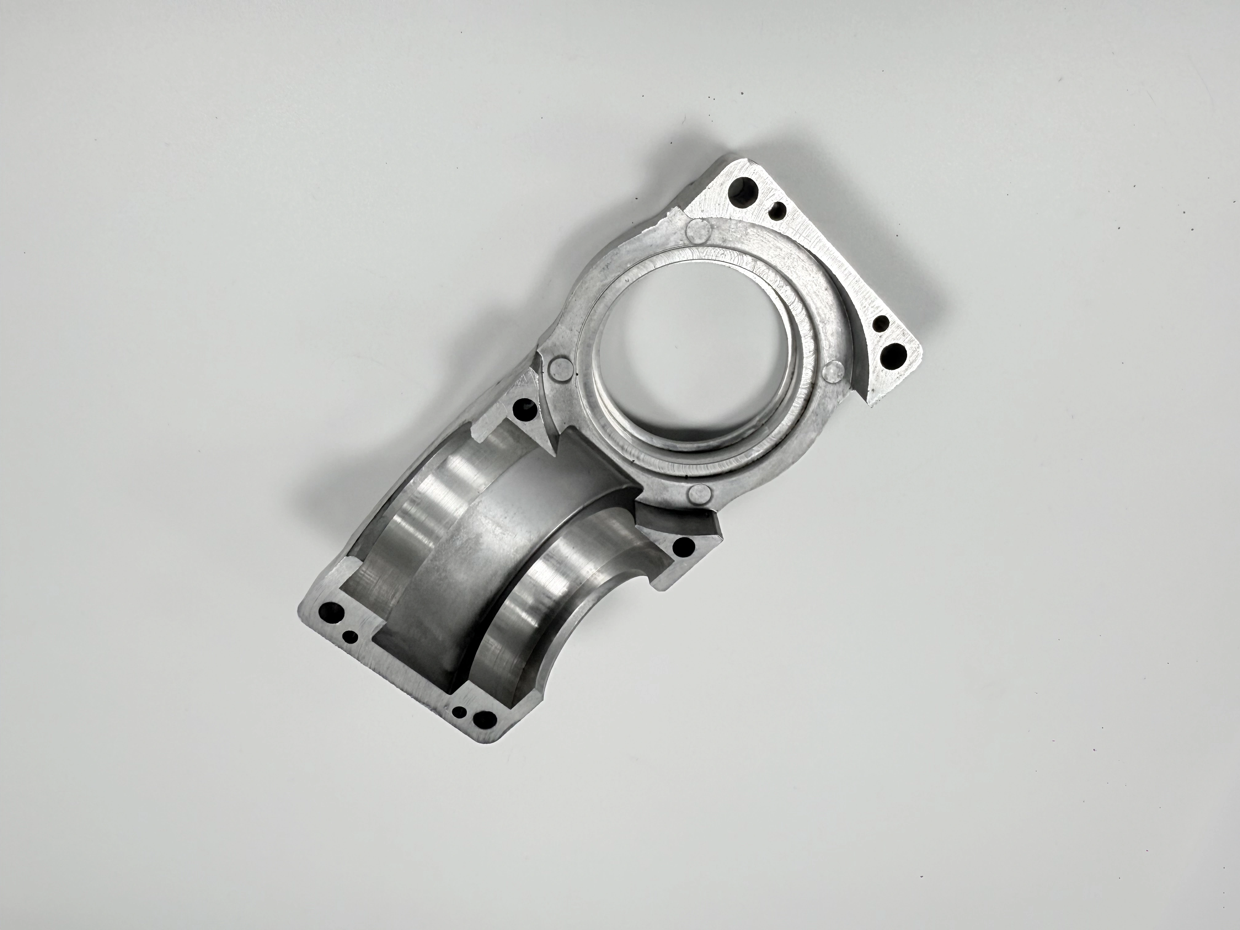 Machined flanged sleeve with bore datum face and mounting holes prepared for inspection
