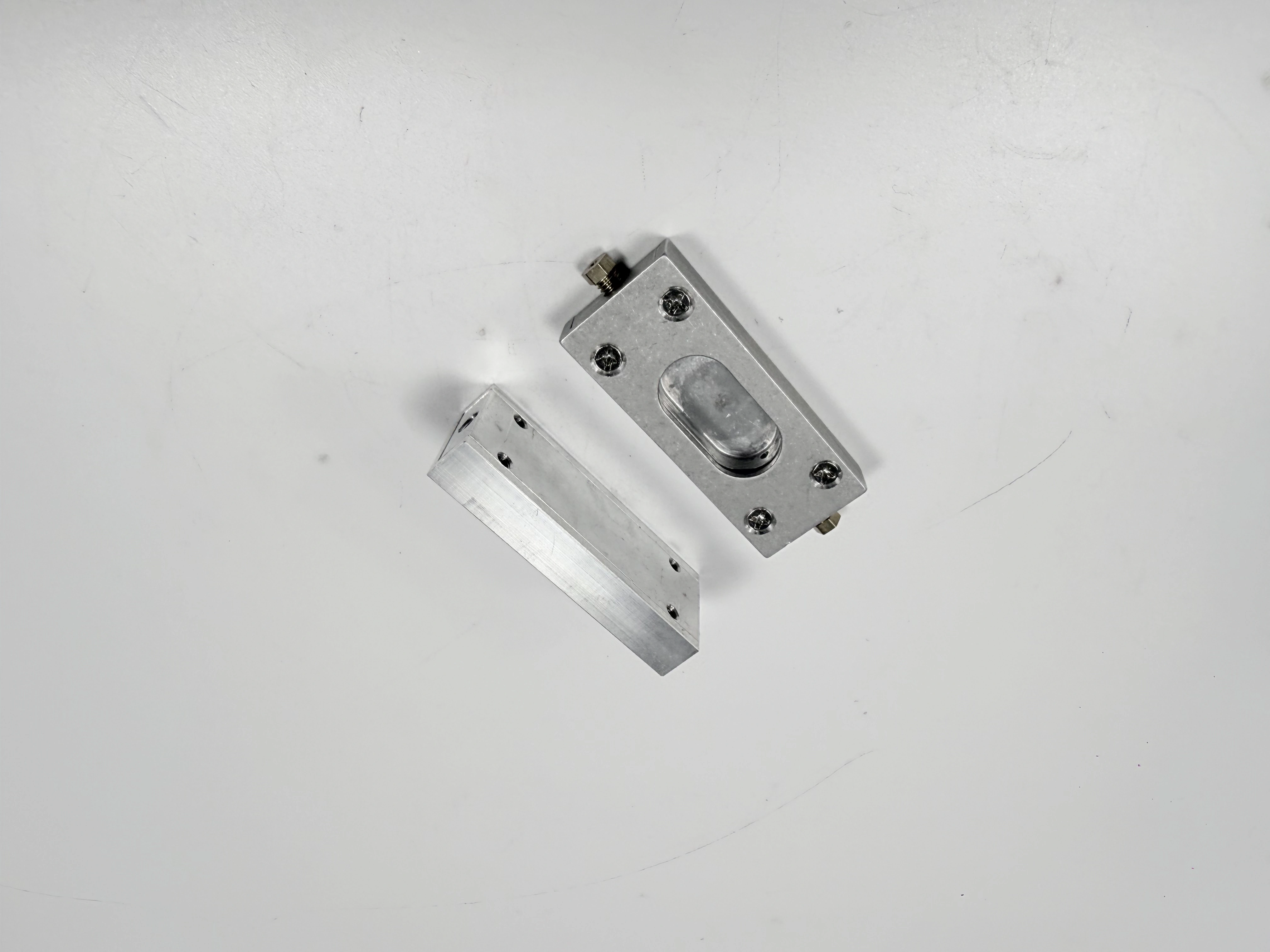 Alternate angled view of the same rectangular milled block and cover
