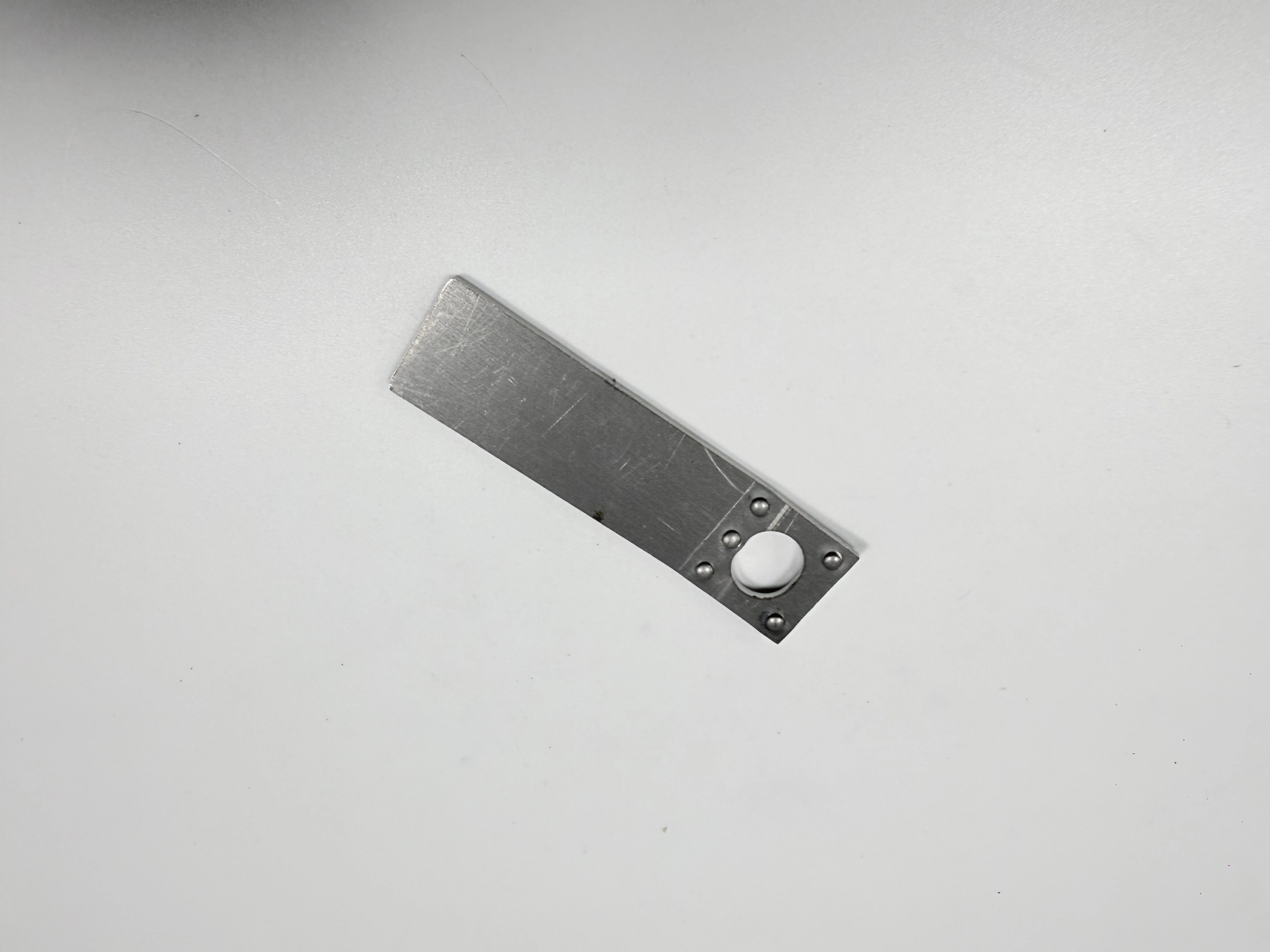 The same long plate shown from an angled view for support and hole-access review