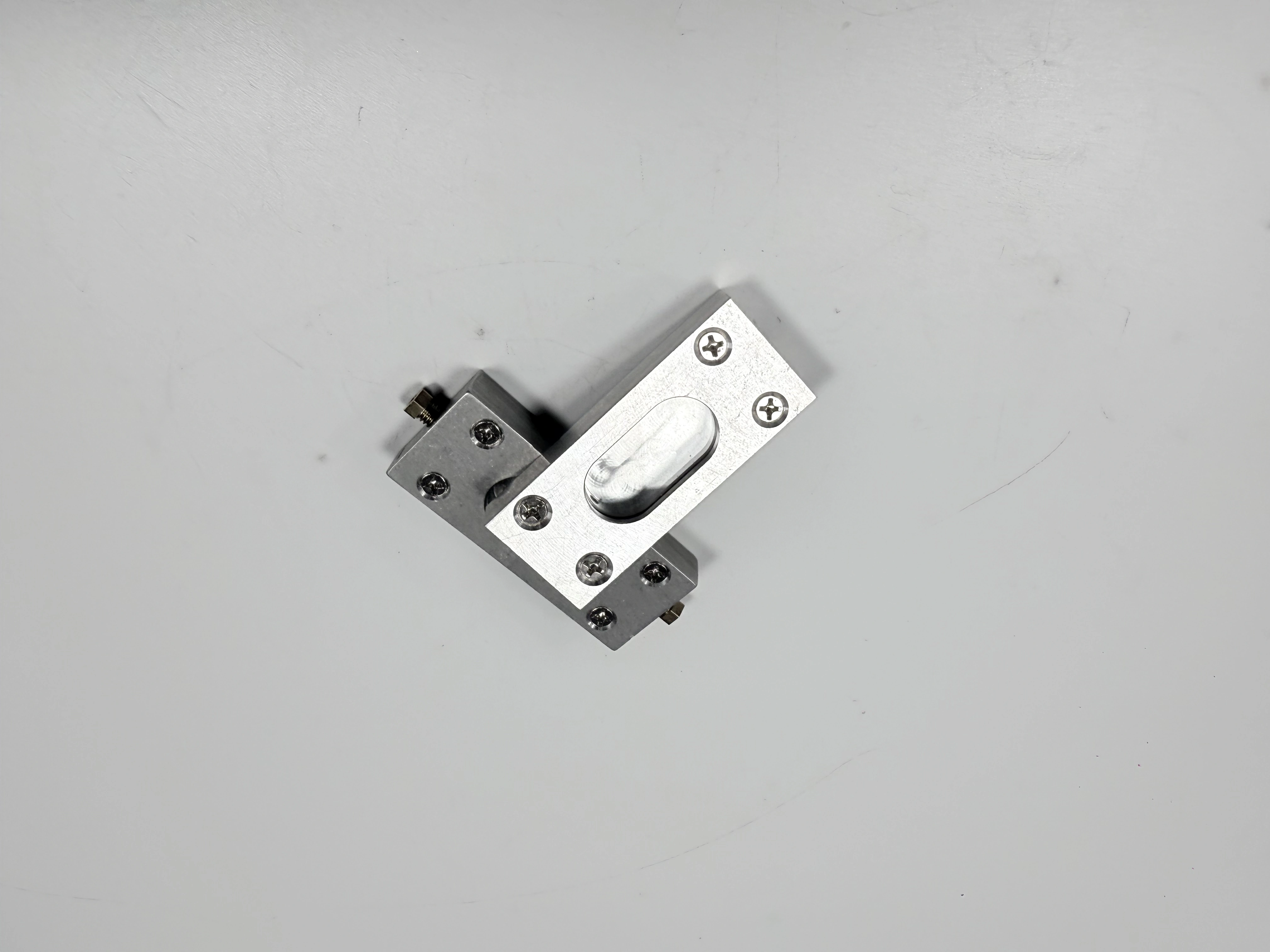 The same silver clamp assembly shown from an angled view