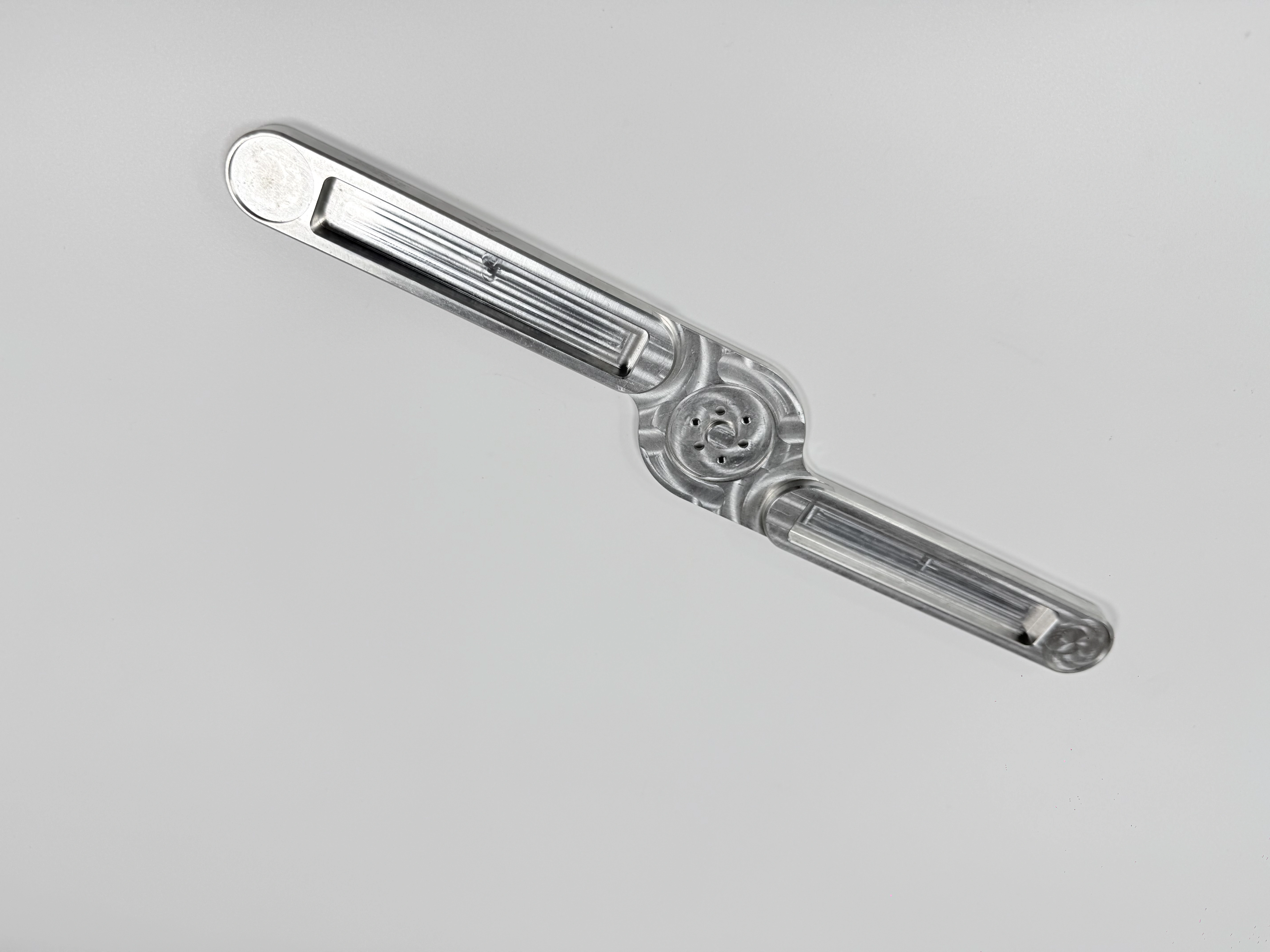 The same link arm shown from an angled view for surface and geometry review