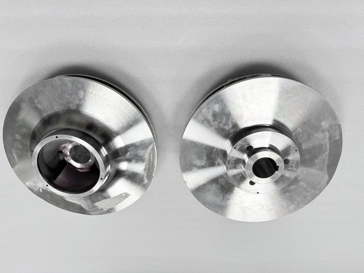 Two closed pump impellers shown from inlet and side views